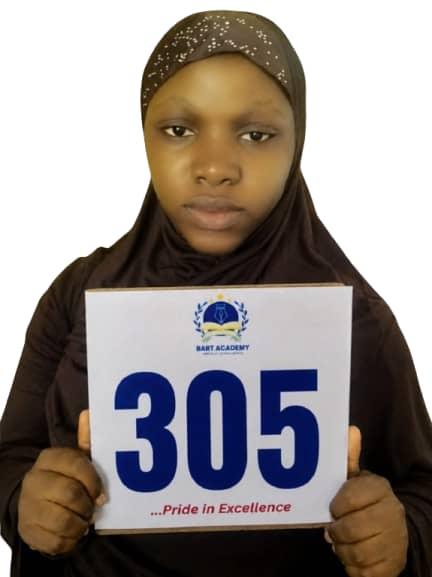 BART ACADEMY student holding a JAMB score card of 305